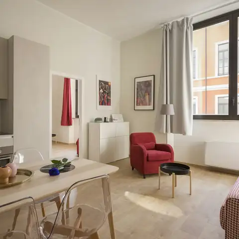 A furnished living room with a red armchair