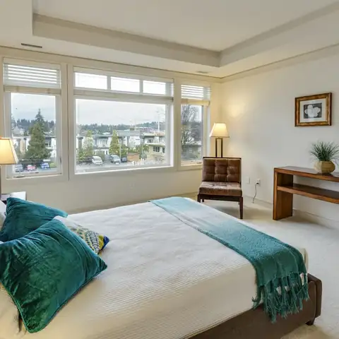 A made bed in a bright bedroom